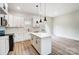 Modern kitchen with light countertops, white cabinets, and herringbone backsplash at 122 Stockbridge Ln, Statesville, NC 28625