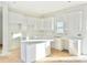 Modern kitchen featuring white cabinets, a center island, and quartz countertops at 122 Stockbridge Ln, Statesville, NC 28625