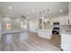 Bright living space connects to the kitchen with recessed lighting and light hard wood floors at 122 Stockbridge Ln, Statesville, NC 28625