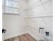 Bright pantry featuring white walls, wood-look flooring, wire shelving, and a window for natural light at 122 Stockbridge Ln, Statesville, NC 28625