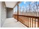 Relaxing porch with stained wood railing and posts and a beautiful wooded view at 122 Stockbridge Ln, Statesville, NC 28625
