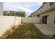 Private backyard featuring a well-maintained lawn, white fence, and sliding glass door access to the home at 138 Lanyard Dr # B, Mooresville, NC 28117