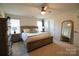 Spacious primary bedroom with large bed, dresser, and full-length mirror at 138 Lanyard Dr # B, Mooresville, NC 28117
