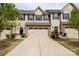 Charming townhome showcasing a well-maintained front yard, gray siding, black shutters and a convenient two-car garage at 138 Lanyard Dr # B, Mooresville, NC 28117