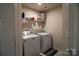 Convenient laundry room with washer, dryer, and shelving at 138 Lanyard Dr # B, Mooresville, NC 28117