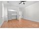 Bright bedroom with hardwood floors, ceiling fan, closet shelving and plenty of natural light at 1408 Camp Greene St, Charlotte, NC 28208