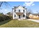 Stunning two-story farmhouse with white siding and a charming front porch at 1408 Camp Greene St, Charlotte, NC 28208