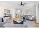 Open living room with hardwood floors, gray sofas, and a ceiling fan at 1408 Camp Greene St, Charlotte, NC 28208