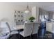 Modern dining room with marble table and kitchen view at 15044 New Amsterdam Ln, Charlotte, NC 28204