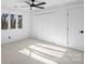 Bright bedroom with a ceiling fan, closet, and natural light streaming through the windows at 19634 Bustle Rd, Cornelius, NC 28031