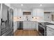 Bright kitchen boasts stainless appliances, white cabinets and subway tile at 19634 Bustle Rd, Cornelius, NC 28031