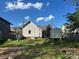 The back of the home features a brick chimney, grassy area, a small shed, and minimal landscaping at 2824 N Brevard St, Charlotte, NC 28205
