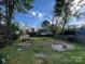 Spacious backyard with a fire pit and fence, offering potential for landscaping and outdoor activities at 2824 N Brevard St, Charlotte, NC 28205