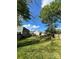 Large backyard, fenced in, with trees, lawn, and some plantings in place, with neighborhood homes nearby at 2824 N Brevard St, Charlotte, NC 28205
