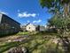 Large backyard featuring a fire pit, a small shed, a privacy fence, and plenty of shade at 2824 N Brevard St, Charlotte, NC 28205