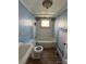 Bathroom featuring a vintage style sink, toilet, and a bath tub with white and blue accents at 2824 N Brevard St, Charlotte, NC 28205
