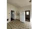 Bright kitchen showcasing white cabinets, refrigerator, and unique patterned flooring at 2824 N Brevard St, Charlotte, NC 28205