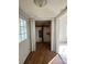 Storage area with exposed support structure, neutral paint, wood-look flooring, and bi-fold doors at 2824 N Brevard St, Charlotte, NC 28205