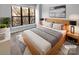 Virtually staged main bedroom with large window and wood floors at 3214 Noda Blvd, Charlotte, NC 28205