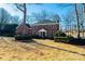 Stately two-story brick home featuring mature landscaping, a manicured lawn, and classic architectural details at 3467 Rock Bridge Dr, Conover, NC 28613