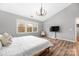 Main bedroom with hardwood floors, large windows, and a TV at 3801 Melshire Ln, Charlotte, NC 28269