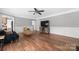 Living room featuring hardwood floors, fireplace, and built-in shelving at 3801 Melshire Ln, Charlotte, NC 28269