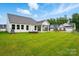 A home's backyard features green grass and a fire pit at 4003 Grace Pointe Dr # 99, Wesley Chapel, NC 28079
