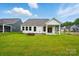 The backyard featuring green grass and a fire pit at 4003 Grace Pointe Dr # 99, Wesley Chapel, NC 28079