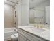 Bathroom with large mirror, tile shower and tub, and white vanity with gold hardware at 4003 Grace Pointe Dr # 99, Wesley Chapel, NC 28079