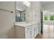 Bathroom vanity features white cabinets, stone countertops, and a view of the tiled shower at 4003 Grace Pointe Dr # 99, Wesley Chapel, NC 28079