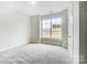 Bright bedroom with large window, carpet, and double doors leading to a closet at 4003 Grace Pointe Dr # 99, Wesley Chapel, NC 28079