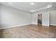Neutral bedroom with a tray ceiling, door, and a peek at an en-suite bathroom at 4003 Grace Pointe Dr # 99, Wesley Chapel, NC 28079