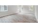 Well-lit bedroom featuring wood-look flooring and multiple windows at 4003 Grace Pointe Dr # 99, Wesley Chapel, NC 28079