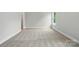 Bright bedroom with neutral carpet, light gray walls, and a large window at 4003 Grace Pointe Dr # 99, Wesley Chapel, NC 28079