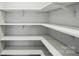 Walk-in closet with multiple white shelving units at 4003 Grace Pointe Dr # 99, Wesley Chapel, NC 28079
