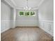 Elegant dining room with white wainscoting and trim, recessed lighting, and hardwood floors at 4003 Grace Pointe Dr # 99, Wesley Chapel, NC 28079