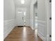 Inviting foyer boasts beautiful wall trim, wood flooring, and a view into the adjacent living space at 4003 Grace Pointe Dr # 99, Wesley Chapel, NC 28079
