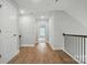 Hallway with wood floors, white doors and trim, and iron railing at 4003 Grace Pointe Dr # 99, Wesley Chapel, NC 28079