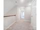 Upstairs hallway with neutral carpeting and access to bedrooms at 4003 Grace Pointe Dr # 99, Wesley Chapel, NC 28079