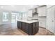 Modern kitchen with white cabinets, an island, and stainless steel appliances at 4003 Grace Pointe Dr # 99, Wesley Chapel, NC 28079