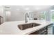 Kitchen island with quartz countertop and stainless steel sink at 4003 Grace Pointe Dr # 99, Wesley Chapel, NC 28079