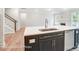 Kitchen island with dark cabinetry and quartz countertop at 4003 Grace Pointe Dr # 99, Wesley Chapel, NC 28079