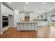 Spacious kitchen with a large island, stainless steel appliances, and white cabinets offer a sleek design at 4003 Grace Pointe Dr # 99, Wesley Chapel, NC 28079