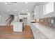 Modern white kitchen showcases a large island, stainless appliances, and abundant cabinet space at 4003 Grace Pointe Dr # 99, Wesley Chapel, NC 28079