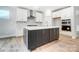 Modern kitchen with white cabinets, an island, and stainless steel appliances at 4003 Grace Pointe Dr # 99, Wesley Chapel, NC 28079