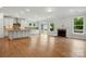 Bright living room featuring an open floor plan, modern fireplace, and hardwood floors at 4003 Grace Pointe Dr # 99, Wesley Chapel, NC 28079