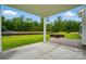 Covered patio overlooking a large backyard with green grass and a fire pit at 4003 Grace Pointe Dr # 99, Wesley Chapel, NC 28079
