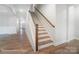 Elegant staircase with wooden handrail and hardwood flooring at 4003 Grace Pointe Dr # 99, Wesley Chapel, NC 28079
