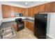 Kitchen with dark wood cabinets and black appliances at 415 Delta Dr, Fort Mill, SC 29715