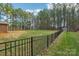 Black metal fence encloses the large backyard at 416 Zelkova St, York, SC 29745